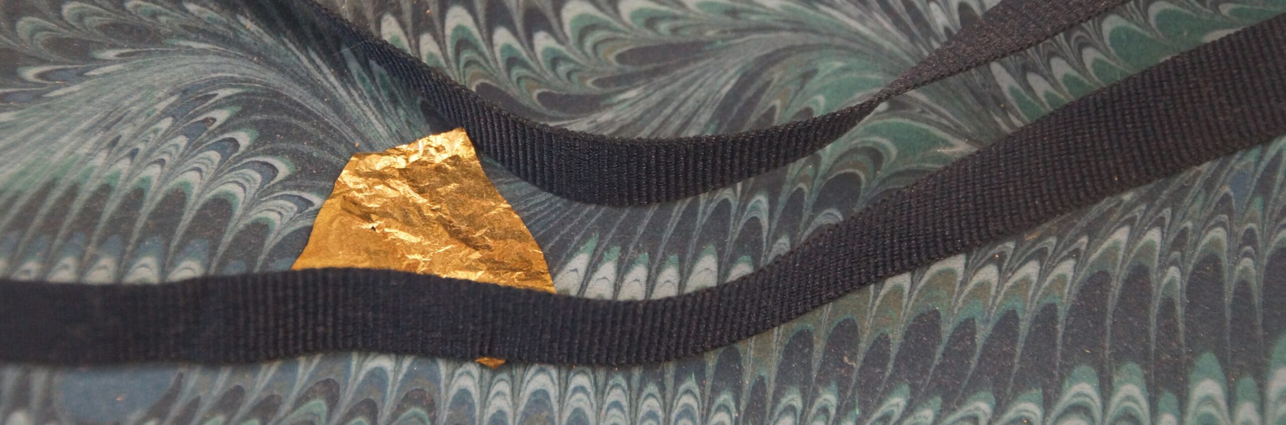 An image of ribbon on Venetian paper.